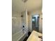 Bathroom featuring a tub with marbled tile walls, and modern sink at 3700 Denson Pl, Charlotte, NC 28215