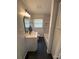 Updated bathroom featuring modern fixtures, marbled tiled tub, and dark tile floor at 3700 Denson Pl, Charlotte, NC 28215