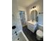 Bathroom featuring a tub with tiled walls, modern vanity, fixtures and dark tile floor at 3700 Denson Pl, Charlotte, NC 28215