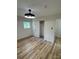 Bright bedroom featuring a modern ceiling light, wood floors, a window, and a closet for ample storage space at 3700 Denson Pl, Charlotte, NC 28215