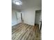Cozy bedroom with wood floors, an open closet, and neutral walls, creating a relaxing and inviting atmosphere at 3700 Denson Pl, Charlotte, NC 28215