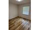 This bedroom features wood flooring and a window, creating a cozy and inviting atmosphere for relaxation at 3700 Denson Pl, Charlotte, NC 28215