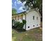 Side view of home with well maintained white painted brick and dark rain gutters at 3700 Denson Pl, Charlotte, NC 28215