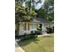 A well-maintained single-story house featuring charming wooden shutters and lush greenery at 3700 Denson Pl, Charlotte, NC 28215