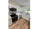 Modern kitchen with stainless steel appliances, white cabinets, and new countertops at 3700 Denson Pl, Charlotte, NC 28215