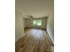 Spacious living room with light wood flooring, ceiling fan, and natural light from large window at 3700 Denson Pl, Charlotte, NC 28215