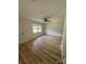 Bright living room featuring light wood flooring, a ceiling fan, and natural light from a window at 3700 Denson Pl, Charlotte, NC 28215