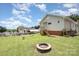 Expansive backyard showcasing an exterior with a fire pit and a fenced perimeter at 380 Woodlawn Ave, Cramerton, NC 28032