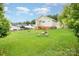 Home offering a spacious backyard with outdoor seating around a fire pit and ample space for gardening at 380 Woodlawn Ave, Cramerton, NC 28032