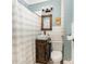 Rustic bathroom featuring a wooden vanity, shiplap walls, and stylish fixtures at 380 Woodlawn Ave, Cramerton, NC 28032