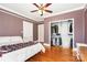 Spacious bedroom featuring a ceiling fan, hardwood floors, and large closet for organization at 380 Woodlawn Ave, Cramerton, NC 28032