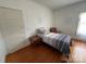 Bedroom with hardwood floors, natural light, and neutral paint at 380 Woodlawn Ave, Cramerton, NC 28032