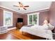 Comfortable bedroom with hardwood floors, natural light, and a ceiling fan for added comfort at 380 Woodlawn Ave, Cramerton, NC 28032