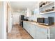 Efficient kitchen featuring modern appliances, light blue cabinets, and a classic tile floor at 380 Woodlawn Ave, Cramerton, NC 28032