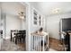 Kitchen view from dining room, highlighting open shelving, tiled floor, and black appliances at 380 Woodlawn Ave, Cramerton, NC 28032
