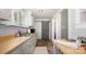 Charming kitchen with wood countertops, updated appliances, and sliding barn door at 380 Woodlawn Ave, Cramerton, NC 28032