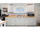 Classic kitchen with white cabinets, wood countertops, and stainless steel sink at 380 Woodlawn Ave, Cramerton, NC 28032