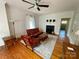 Bright living room featuring a fireplace, ceiling fan, and hardwood floors at 380 Woodlawn Ave, Cramerton, NC 28032