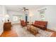 Bright and airy living room with hardwood floors, floral seating, and a cozy ambiance at 380 Woodlawn Ave, Cramerton, NC 28032