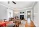 Inviting living room with hardwood floors, a charming fireplace, and an open doorway to the dining area at 380 Woodlawn Ave, Cramerton, NC 28032