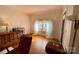 Bright living room with hardwood floors, a ceiling fan, and a large window at 380 Woodlawn Ave, Cramerton, NC 28032