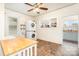 Bright mud room with stacked laundry, open shelving, and a convenient pass-through to the kitchen at 380 Woodlawn Ave, Cramerton, NC 28032