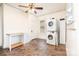 Cozy mud room featuring a stacked washer and dryer, cabinetry, and tile flooring at 380 Woodlawn Ave, Cramerton, NC 28032