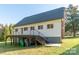 Rear exterior features a deck overlooking the expansive yard, with a convenient staircase and mature trees at 3921 Bon Rea Dr, Charlotte, NC 28226