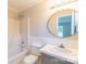 Traditional bathroom with a tub/shower combo, sink, and round mirror at 3921 Bon Rea Dr, Charlotte, NC 28226