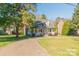 Charming home with a welcoming front porch, driveway and meticulously manicured lawn at 3921 Bon Rea Dr, Charlotte, NC 28226