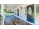 Cozy front porch with decorative hanging plants and a dark-colored front door at 3921 Bon Rea Dr, Charlotte, NC 28226