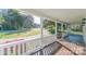 Spacious front porch with white railings and a view of the surrounding greenery at 3921 Bon Rea Dr, Charlotte, NC 28226