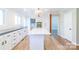 Well-lit kitchen with white cabinets, island, stainless steel appliances, and an adjacent breakfast nook at 3921 Bon Rea Dr, Charlotte, NC 28226