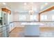 Stylish kitchen featuring a center island, stainless steel refrigerator, and modern lighting at 3921 Bon Rea Dr, Charlotte, NC 28226