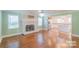 Bright living room with a decorative fireplace and seamless transition to the kitchen at 3921 Bon Rea Dr, Charlotte, NC 28226