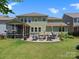 Expansive backyard featuring a patio, screened porch, and well-manicured lawn at 4013 Hamilton Mill Dr, Waxhaw, NC 28173