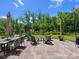 Beautiful backyard patio features an outdoor dining area and fire pit for cozy evenings at 4013 Hamilton Mill Dr, Waxhaw, NC 28173