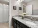 This full bathroom includes double sinks, granite countertops, white cabinets, framed mirrors, and a shower and tub combo at 4013 Hamilton Mill Dr, Waxhaw, NC 28173