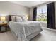 A cozy bedroom featuring a comfortable bed with stylish pillows, neutral walls, and a bright window with dark curtains at 4013 Hamilton Mill Dr, Waxhaw, NC 28173