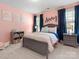 This charming bedroom features playful decor, a comfortable bed, and a bright, cheerful atmosphere with blue curtains at 4013 Hamilton Mill Dr, Waxhaw, NC 28173