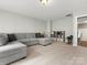 Versatile bonus room with comfortable seating and shelving, ideal for a playroom, media space, or living area at 4013 Hamilton Mill Dr, Waxhaw, NC 28173