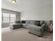 Spacious bonus room with a comfortable sectional sofa, perfect for relaxation and entertainment at 4013 Hamilton Mill Dr, Waxhaw, NC 28173