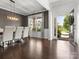 Formal dining room with stylish light fixture, hardwood floors, and large window at 4013 Hamilton Mill Dr, Waxhaw, NC 28173