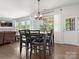 Dining room featuring a black wood table set with black leather chairs with natural light at 4013 Hamilton Mill Dr, Waxhaw, NC 28173
