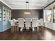Elegant dining area featuring a modern chandelier, six chairs, and a bright china cabinet at 4013 Hamilton Mill Dr, Waxhaw, NC 28173