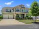 Charming two-story home features a well-manicured lawn, inviting porch, and a two car garage at 4013 Hamilton Mill Dr, Waxhaw, NC 28173