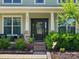 Close-up of the home's front door, featuring a decorative wreath and manicured landscaping at 4013 Hamilton Mill Dr, Waxhaw, NC 28173