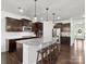 Spacious kitchen with stainless steel appliances, granite countertops and dark wood cabinetry with pendant lights at 4013 Hamilton Mill Dr, Waxhaw, NC 28173