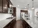 Gourmet kitchen featuring granite countertops, stainless appliances, dark wood cabinets and hardwood floors at 4013 Hamilton Mill Dr, Waxhaw, NC 28173