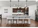Well-lit kitchen featuring a large island, granite countertops, dark wood cabinets and stainless steel appliances at 4013 Hamilton Mill Dr, Waxhaw, NC 28173